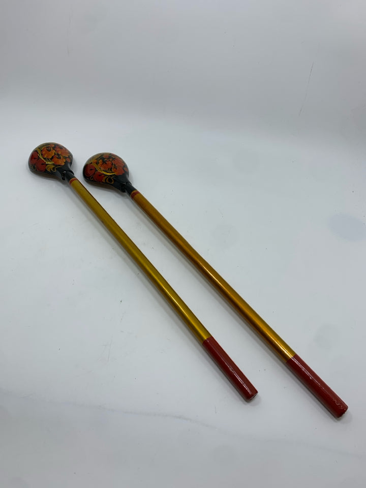 2 GOLD PAINTED LONG HANDLED WOODEN SPOONS.