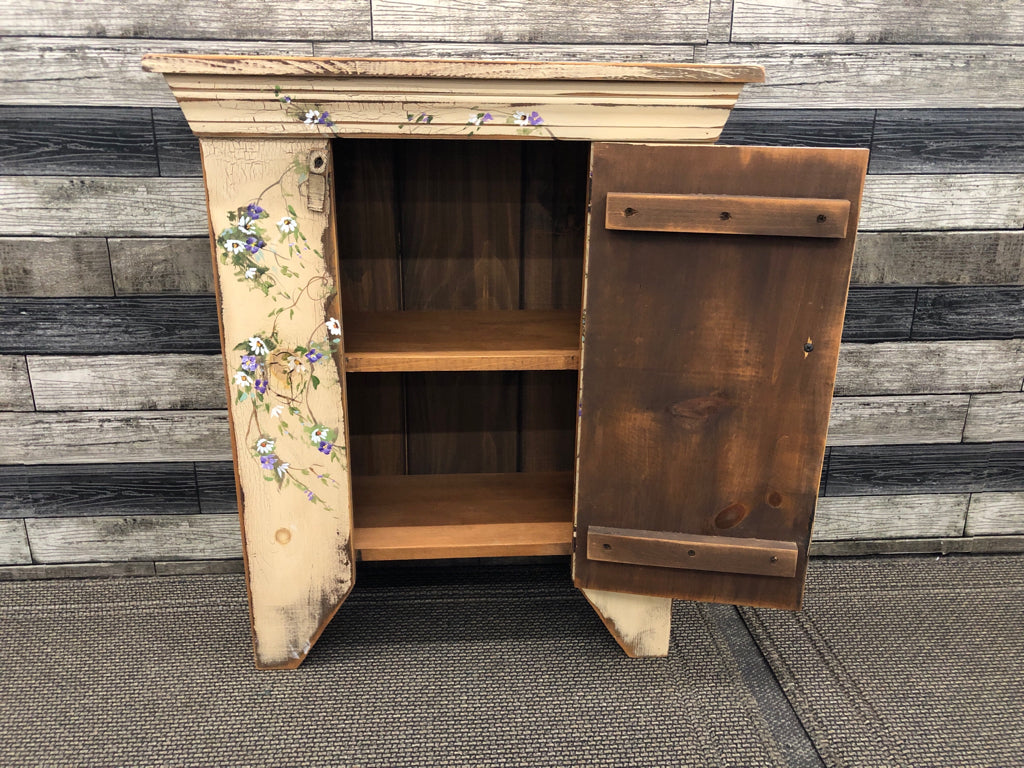 PRIMITIVE STYLE TAN CABINET- 2 SHELVES HAND PAINTED WREATH W/ PURPLE/WHITE FLOWE