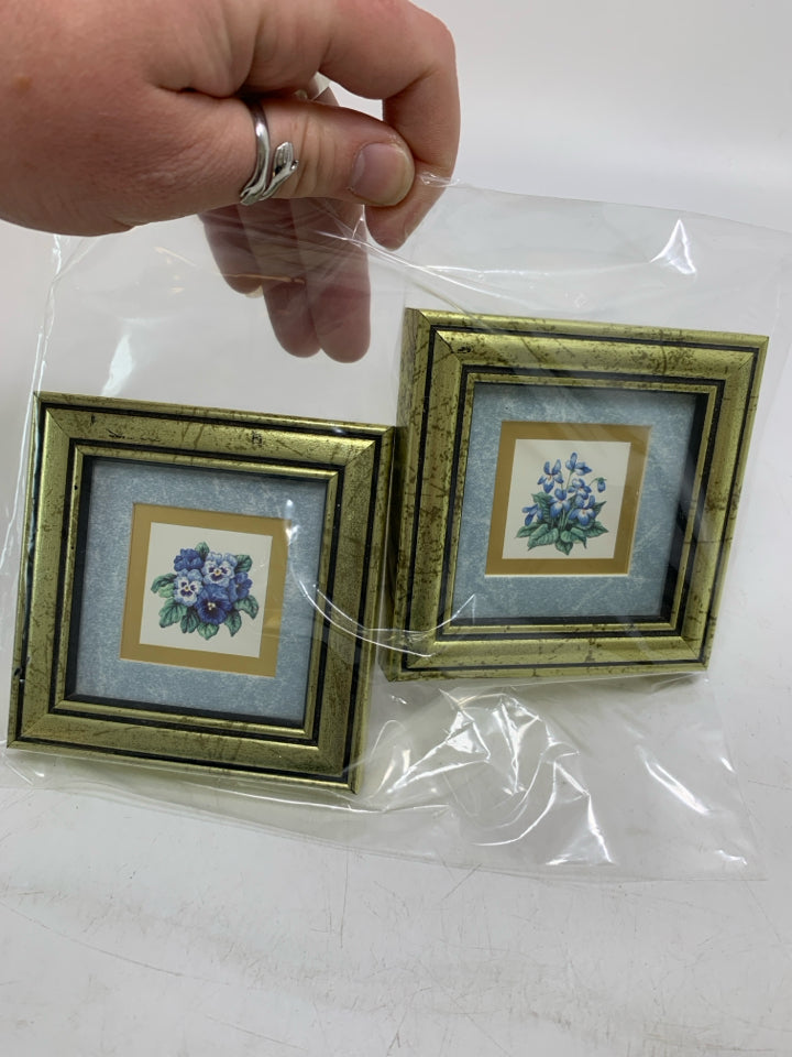 2 MINI VIOLET/PANSY FLOWER PICTURES IN GOLD FRAMES IN BAG.