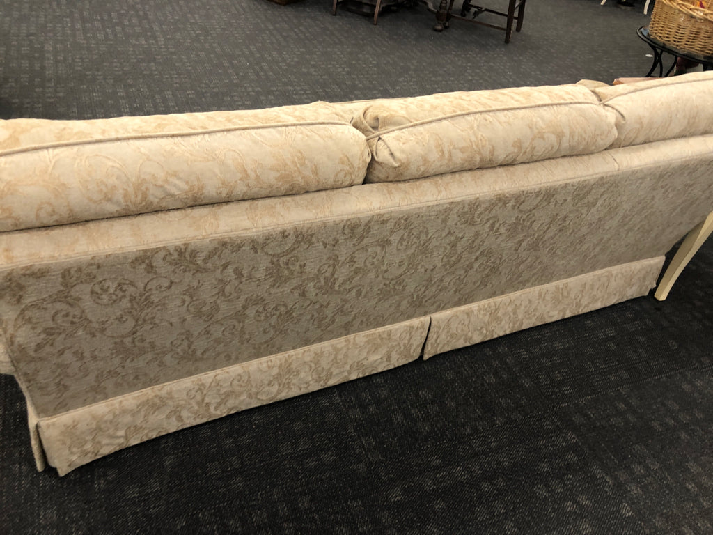 CREAM VELVET SOFA W/ EMBOSSED SCROLL DESIGN.