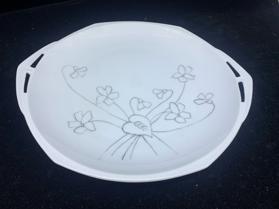 WHITE OVAL SERVING DISH WITH HAND DRAWN FLORAL DESIGN.