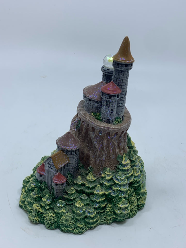 CASTLE WITH CRYSTAL BALL FIGURINE.