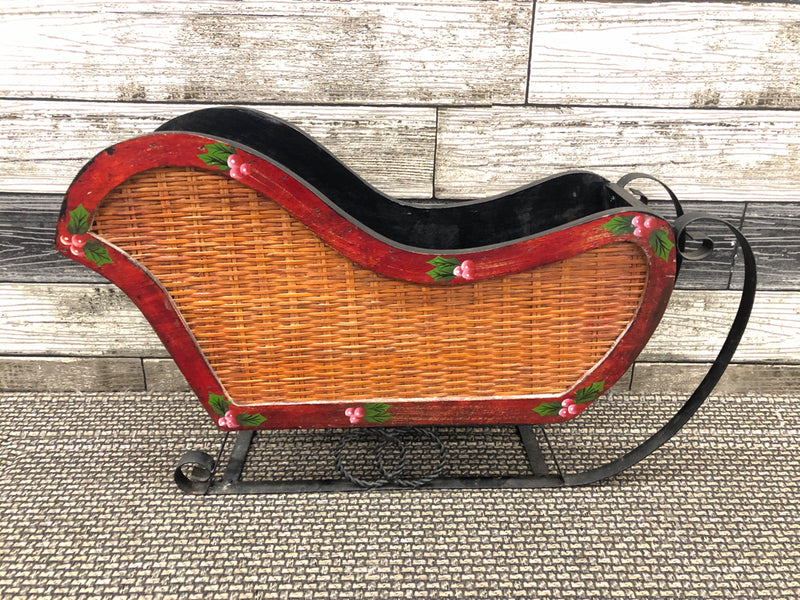 WOOD SLEIGH W/ WICKER SIDES + METAL ACCENTS.