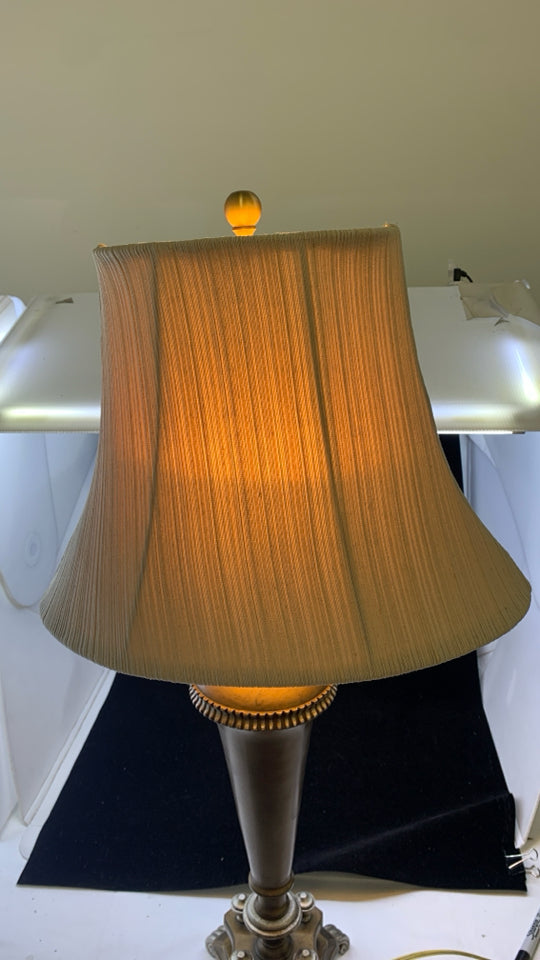 BRONZE BASE TABLE LAMP W/TAN TEXTURED STRIPE SHADE.