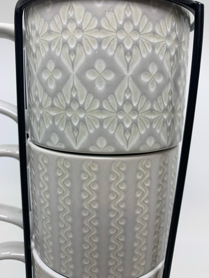 4 STACKING EMBOSSED MUGS IN STAND.