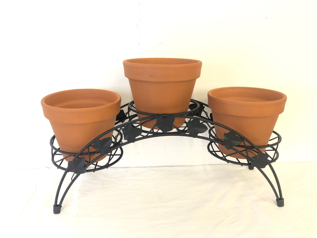 BLACK METAL PLANT STAND W 3 TERA COTTA PLANTERS.