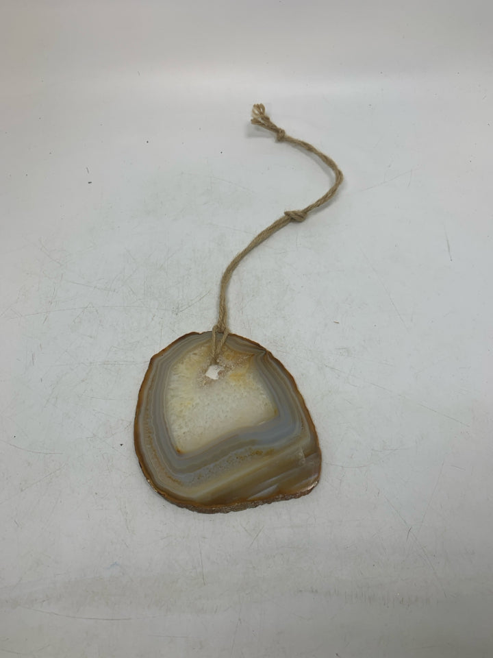 CRYSTAL ROCK SLICE W/ HOLE IN CENTER WALL HANGING.
