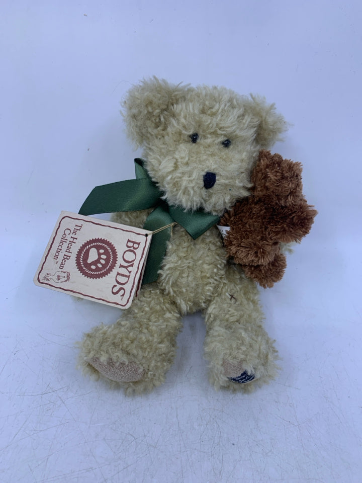 SMALL BEIGE SHAG BEAR HOLDING BROWN BEAR.