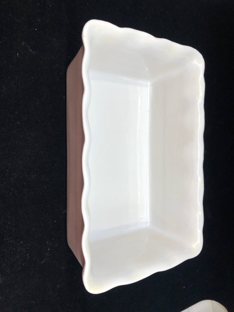 WHITE WAVY EDGE STONEWARE LOAF PAN.