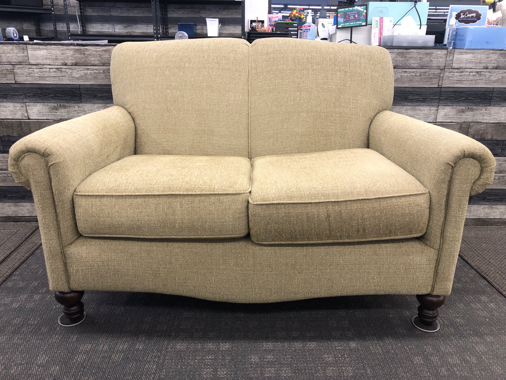 ARTICHOKE GREEN LOVE SEAT W/ BROWN WOOD LEGS.