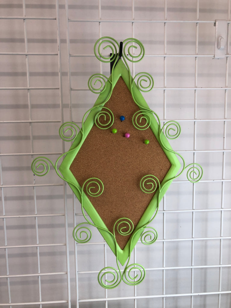 GREEN METAL SCROLL CORK BOARD.