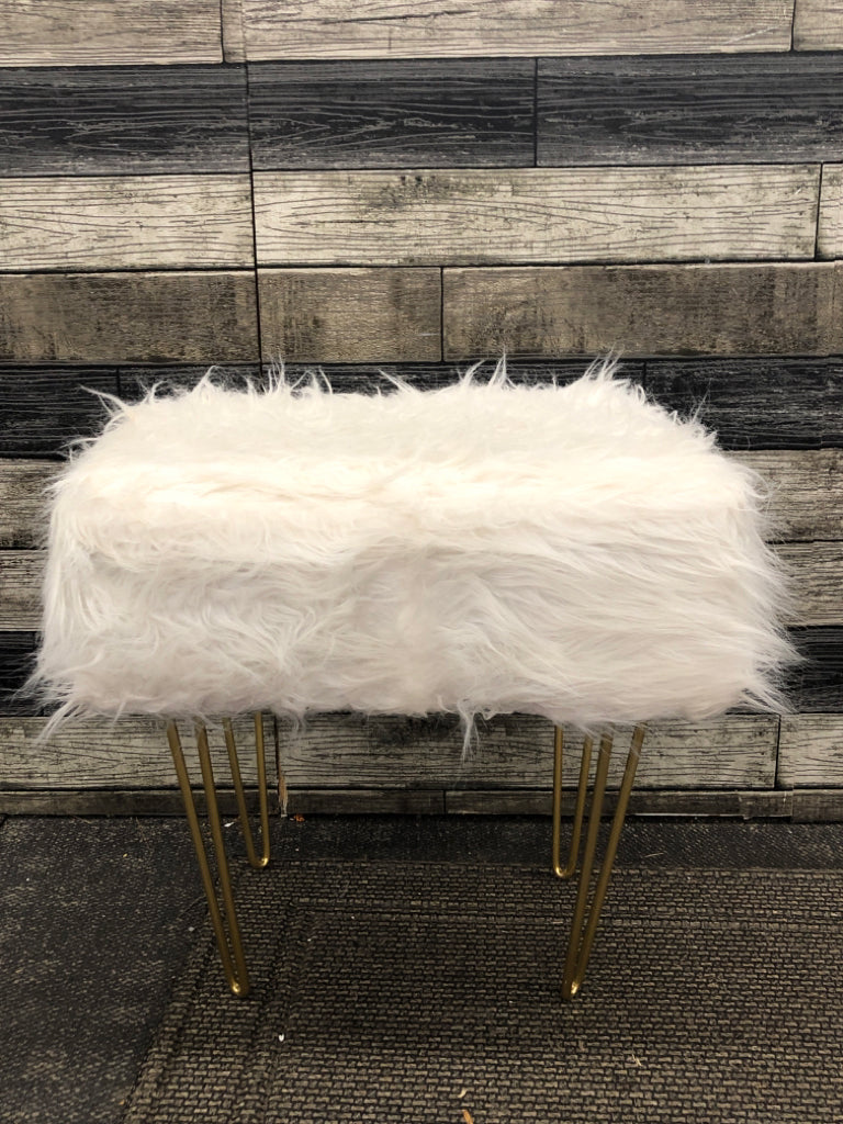 WHITE FURRY FOOTSTOOL W/GOLD LEGS.