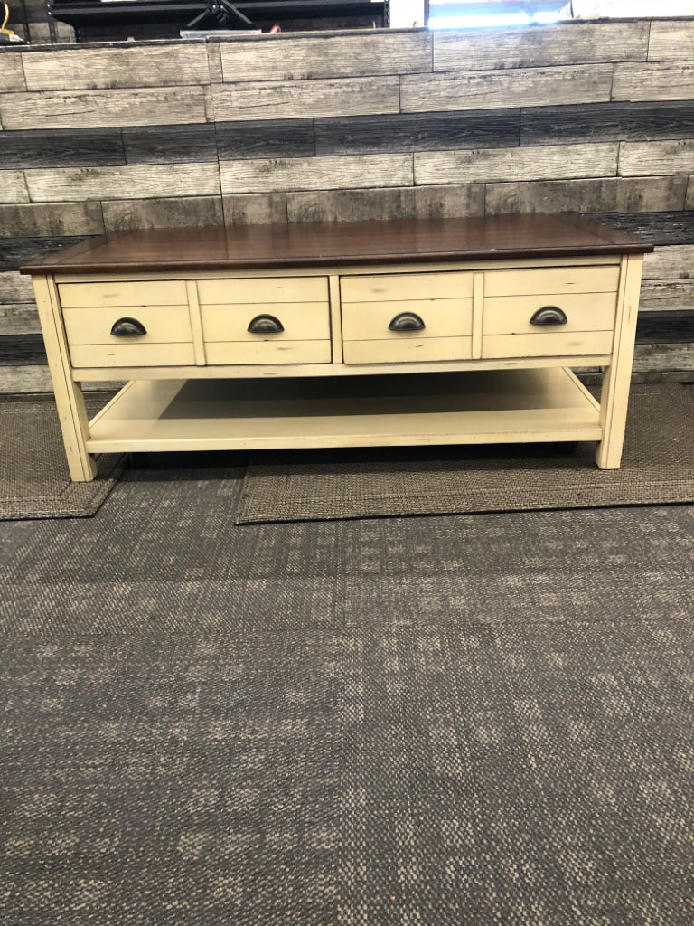 CREAM AND DARK WOOD TOP DISTRESSED COFFEE TABLE.