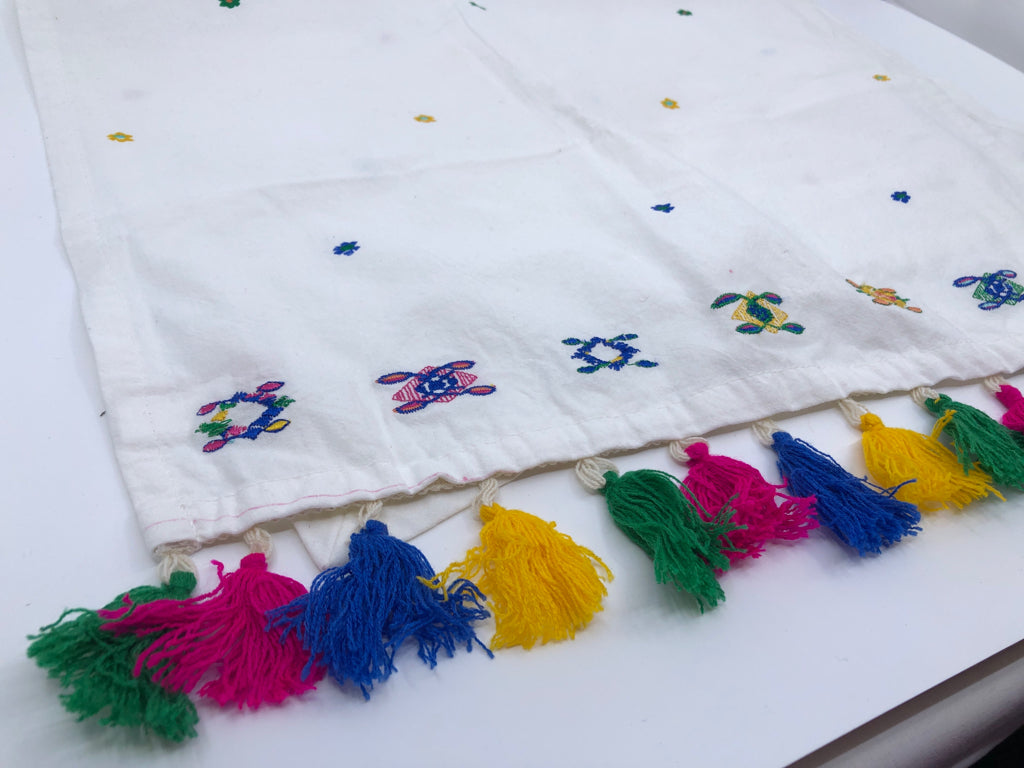 WHITE W/ COLORFUL TASSEL TOWEL.