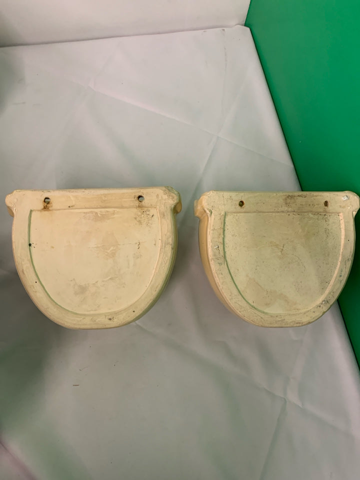 2 TAN CERAMIC WALL HANGING PLANTERS.