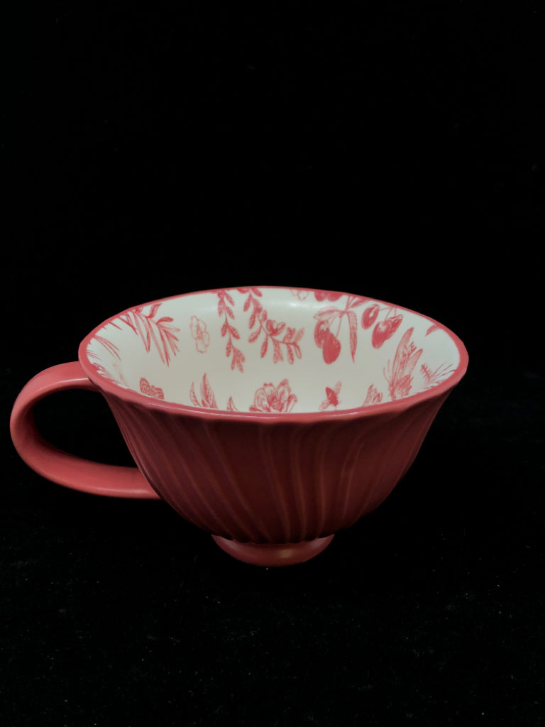 RED MUG W/FLORAL DETAILS INSIDE.