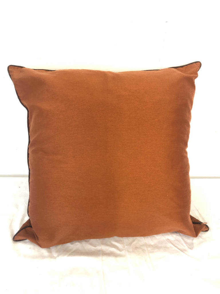 BURNT ORANGE PILLOW W/ STITCHED PATTERN.