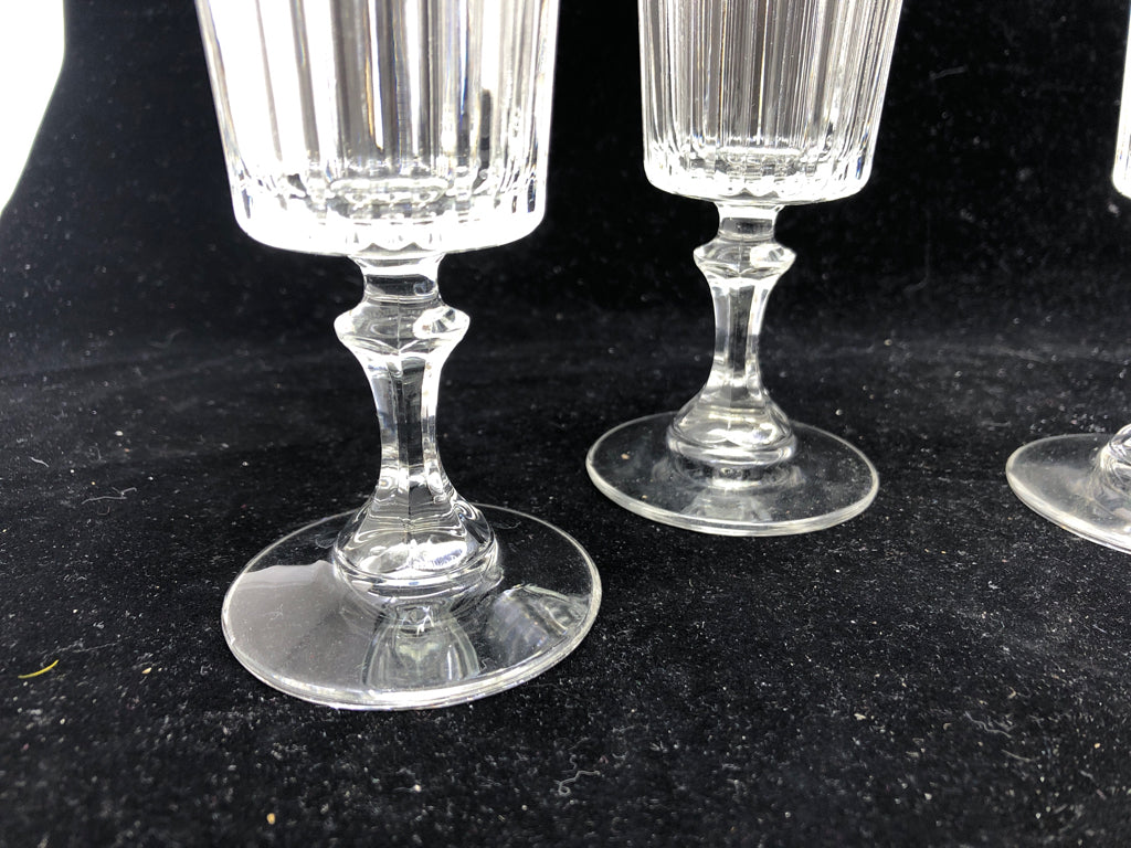 4 FOOTED CHAMPAGNE GLASS CUT GLASS BOTTOM.