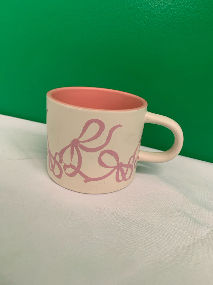WHITE MATTE MUG W PINK BOWS AND WHITE CAT INSIDE.