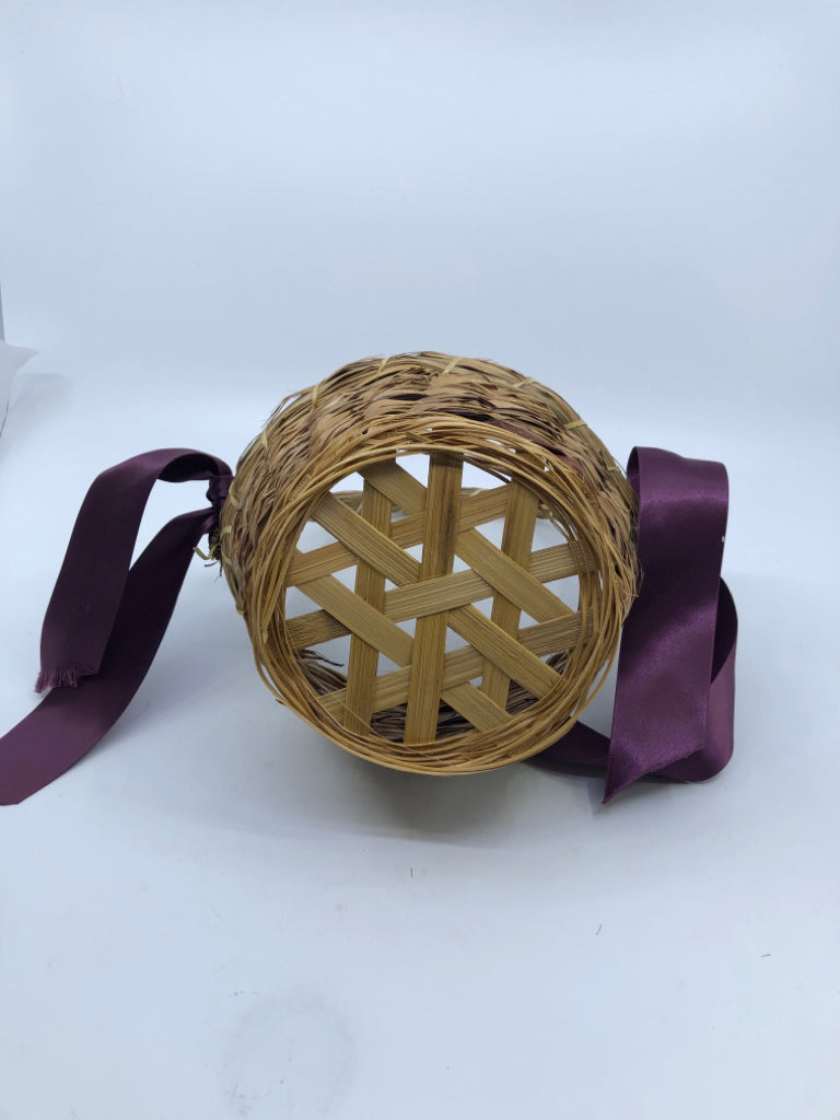 WICKER BASKET W/HANDLE AND PURPLE RIBBONS.