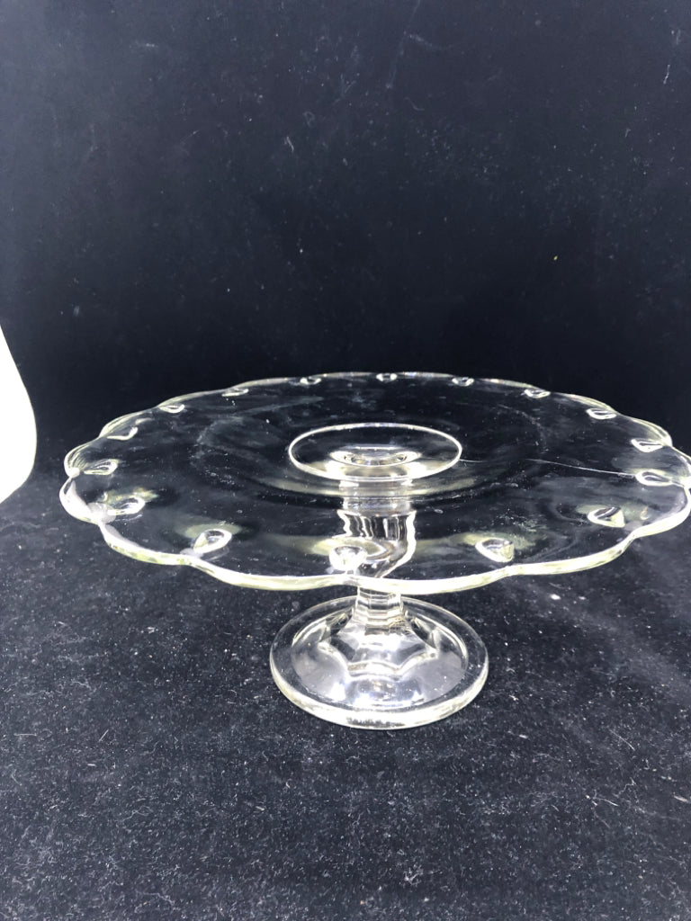 FOOTED GLASS CAKE STAND W DOT PATTERN AND WAVY EDGES.