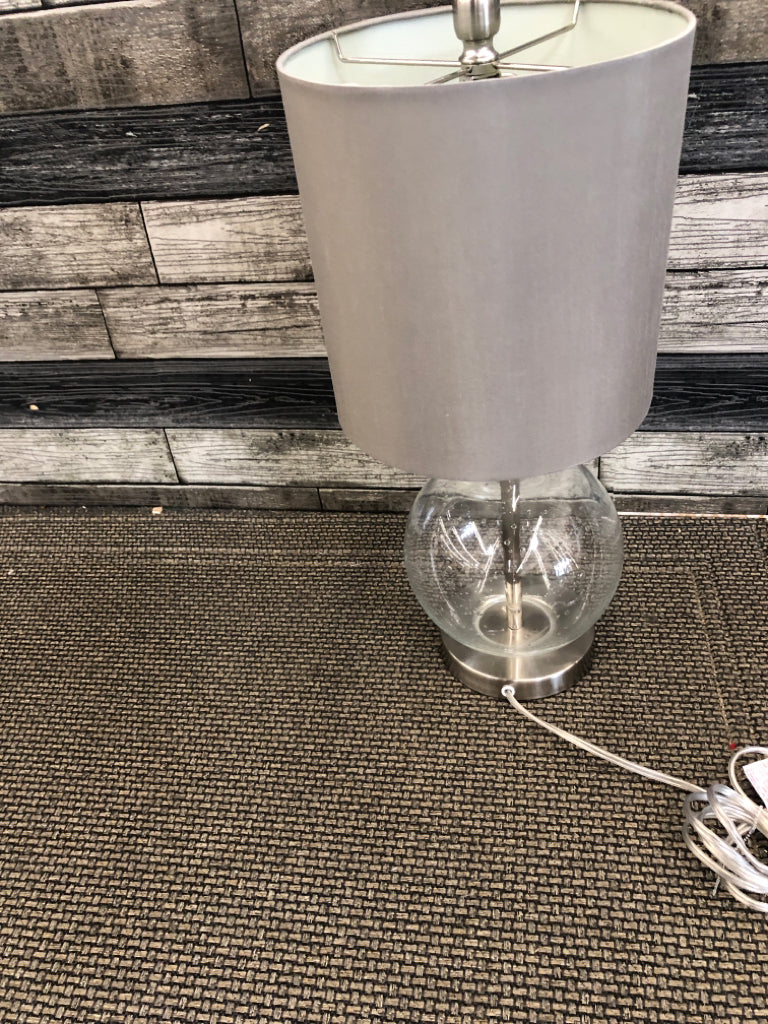 GLASS ROUND BASE LAMP WITH GREEN SHADE.