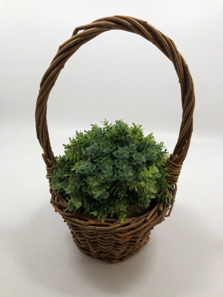 FAUX GREENERY IN HANGING WICKER BASKET.