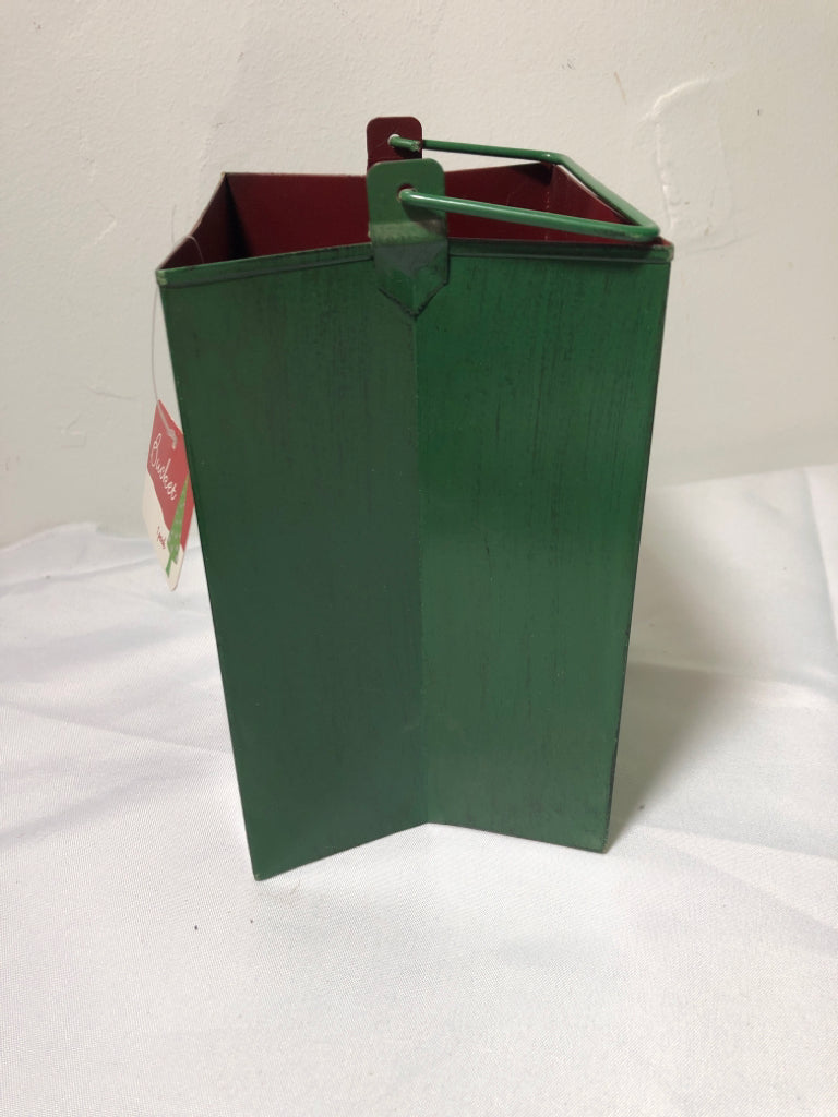 GREEN METAL PIERCED BAG CANDLE HOLDER W HANDLES.