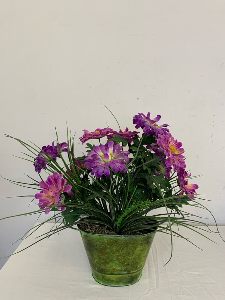 GREEN VASE W/PURPLE FAUX FLOWERS.