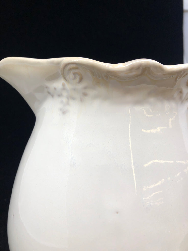 CREAM W SLIGHT EMBOSSED RIM PITCHER.