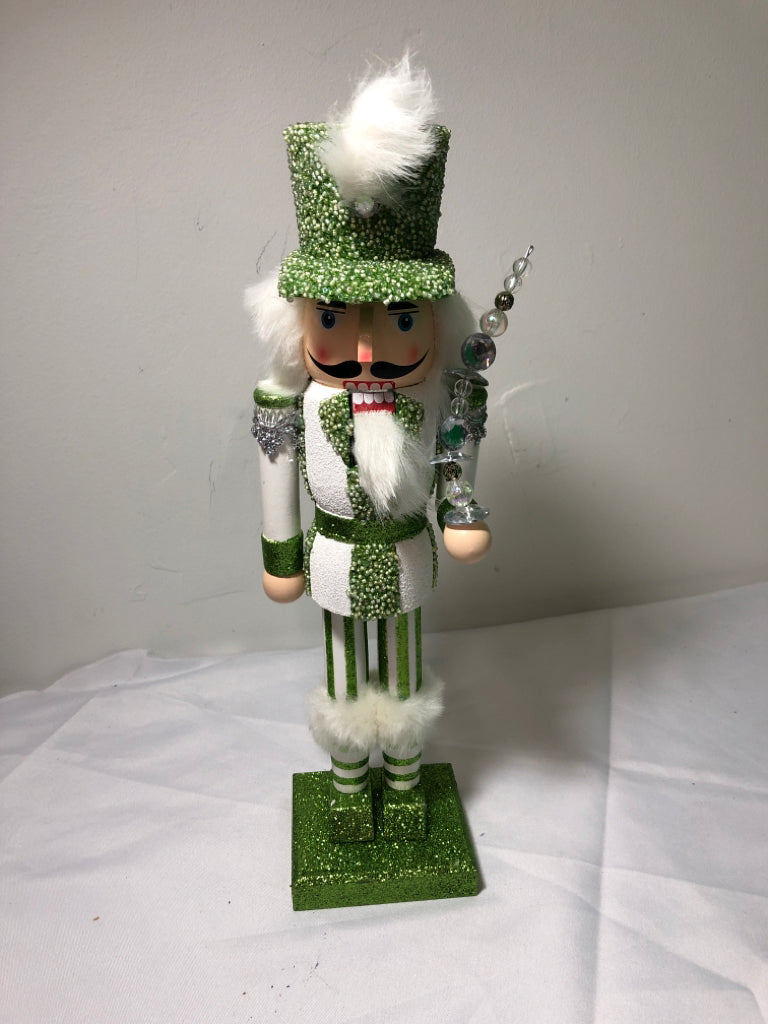GREEN AND WHITE GLITTER NUT CRACKER.