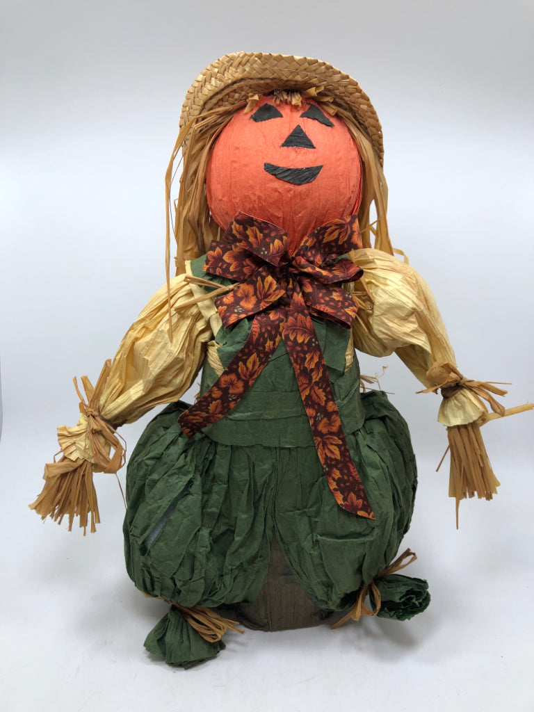 STRAW SCARECROW W/GREEN OVERALLS.