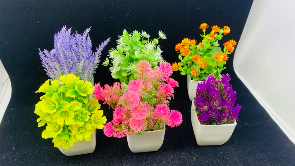 6 FAUX FLOWERS IN WHITE POTS.