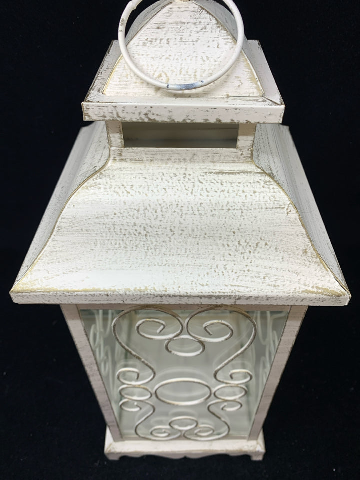 DISTRESSED WHITE LANTERN CANDLE HOLDER W/CURLED WIRE SIDES & CIRCLE HANDLE.