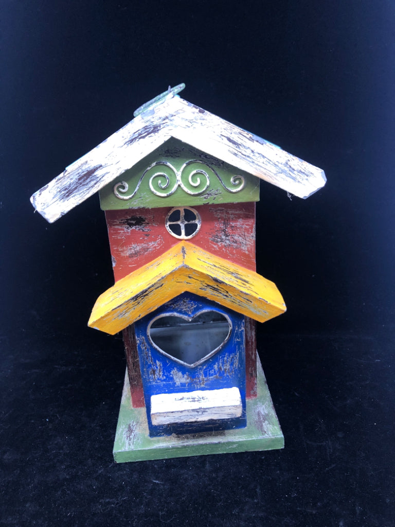 MULTI COLORED TIN BIRD HOUSE W/ PULL OUT TRAY/HEART CUT OUT.