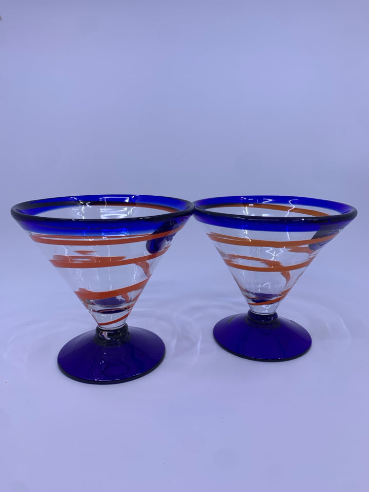2 BLOWN GLASS FOOTED MARTINI GLASSES W/ COBALT BLUE W/ORANGE SWIRL.