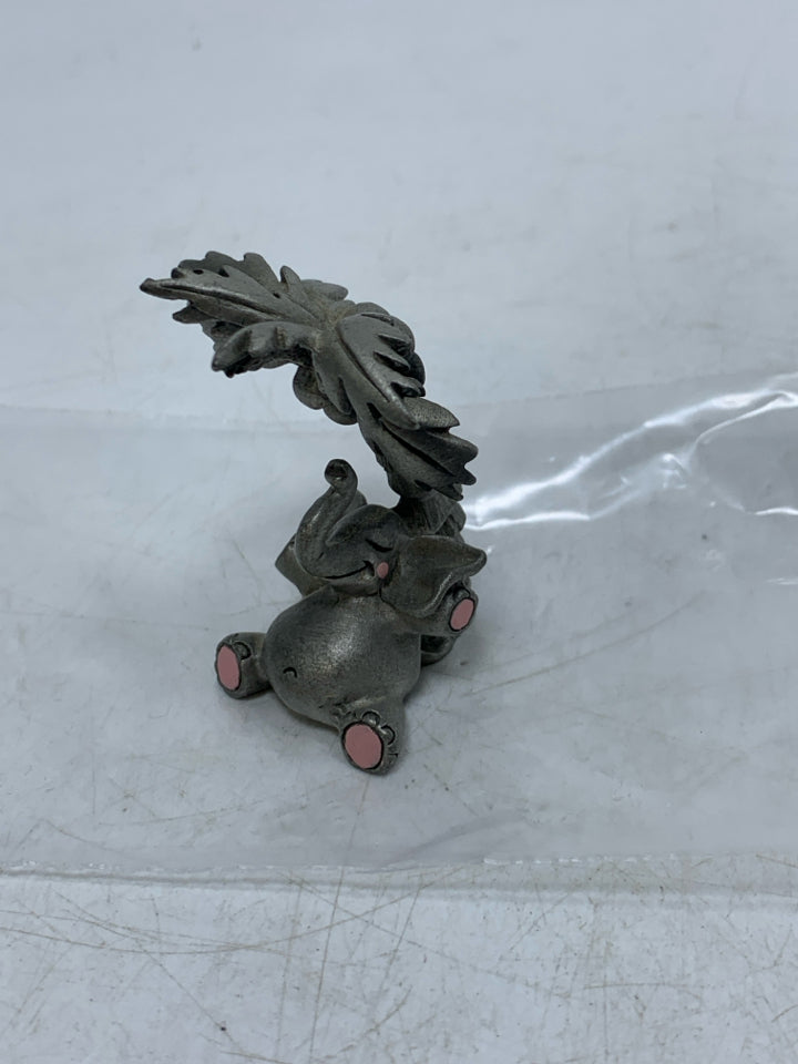 ELEPHANT UNDER PALM TREE FIGURINE.