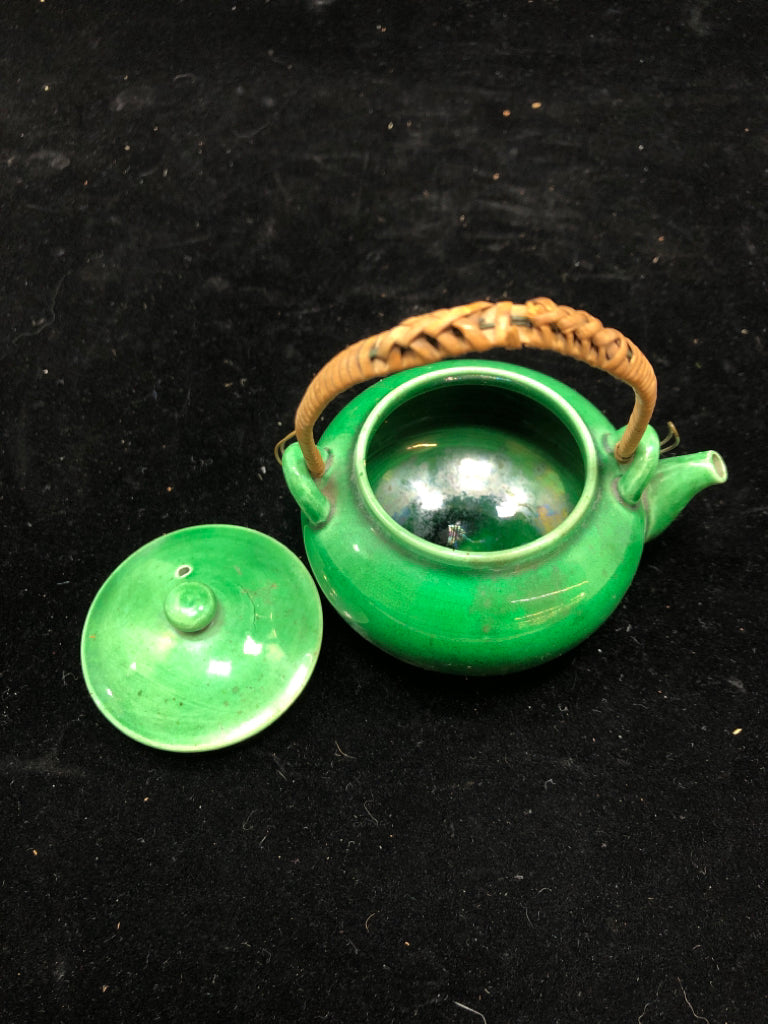 SMALL GREEN GLAZED TEA POT W/WICKER HANDLE.