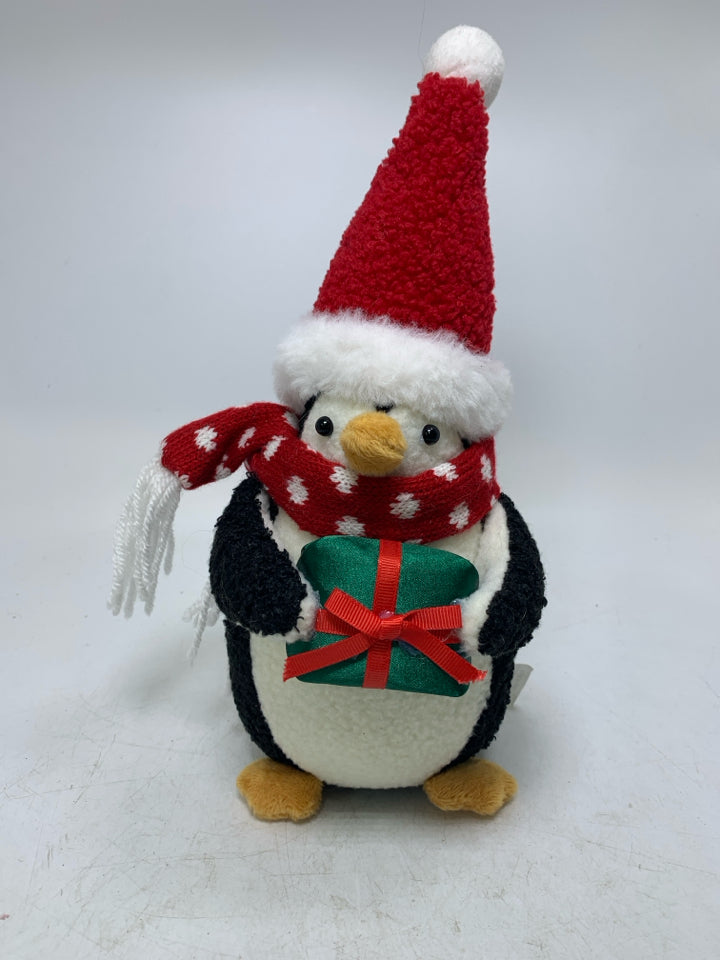 WEIGHTED PENGUIN HOLDING PRESENT.