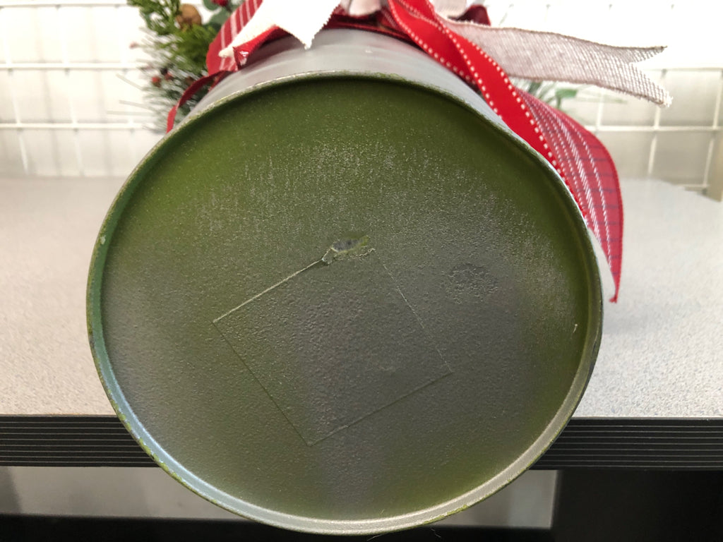 FAUX GREEN AND BERRIES ELF LEGS IN TIN W/RED RIBBON.