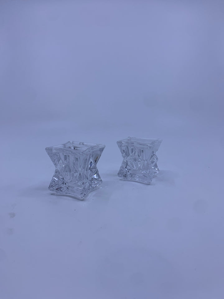 2 SMALL CLEAR GLASS CANDLE STICKS.