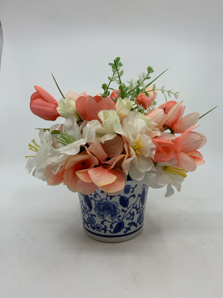 PINK AND WHITE FAUX FLORAL IN BLUE AND WHITE VASE.