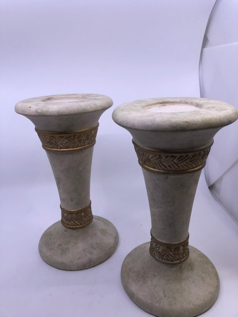 2 WHITE STONE W/GOLD DETAIL PILLAR CANDLE HOLDERS.