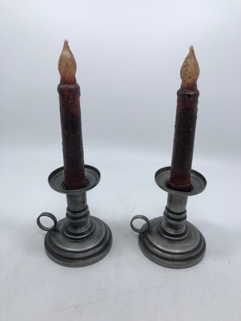 2 PEWTER COLORED TAPERED CANDLE HOLDER W/ PRIMITIVE STYLE CANDLES.