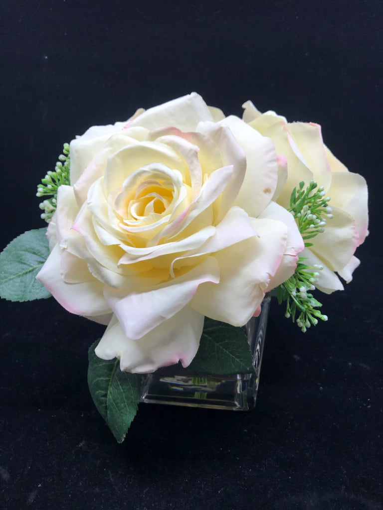 3 LARGE FAUX WHITE ROSES IN CLEAR SQUARE GLASS VASE.