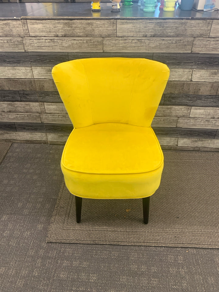 BRIGHT YELLOW VELVET LOW ACCENT CHAIR W/ BLACK LEGS.