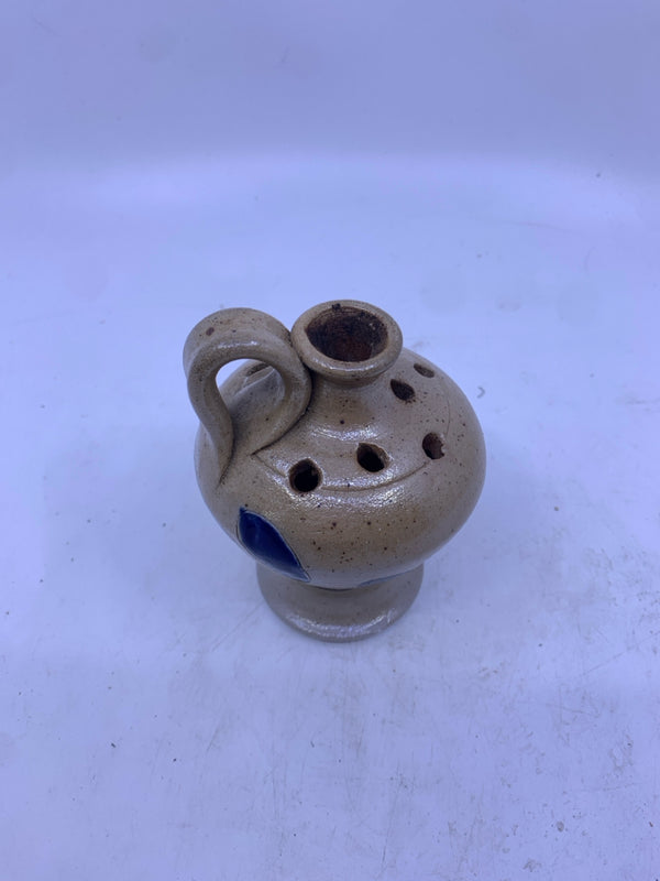 POTTERY VASE W/ PIERCED HOLES ON TOP W/ 2 BLUE LEAVES.