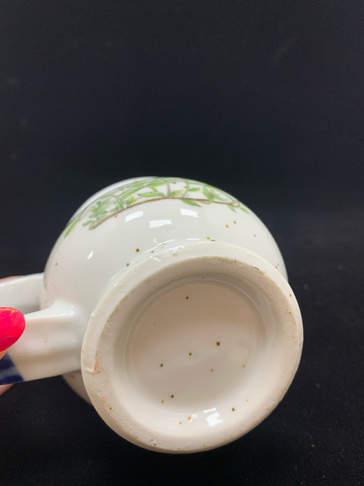 BLUE CERAMIC DOTTED MUG W/ORANGE FLOWERS.