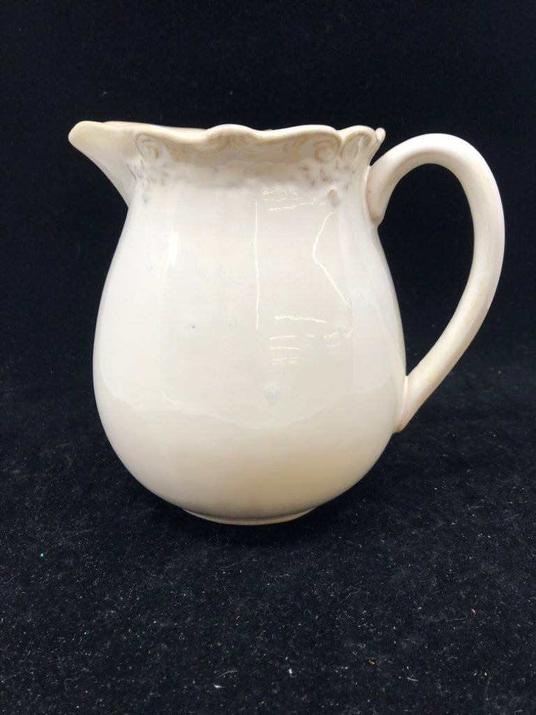 CREAM W SLIGHT EMBOSSED RIM PITCHER.