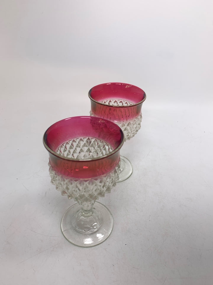 2 STUDDED SMALL WINE GLASSES W/ RED EDGES.